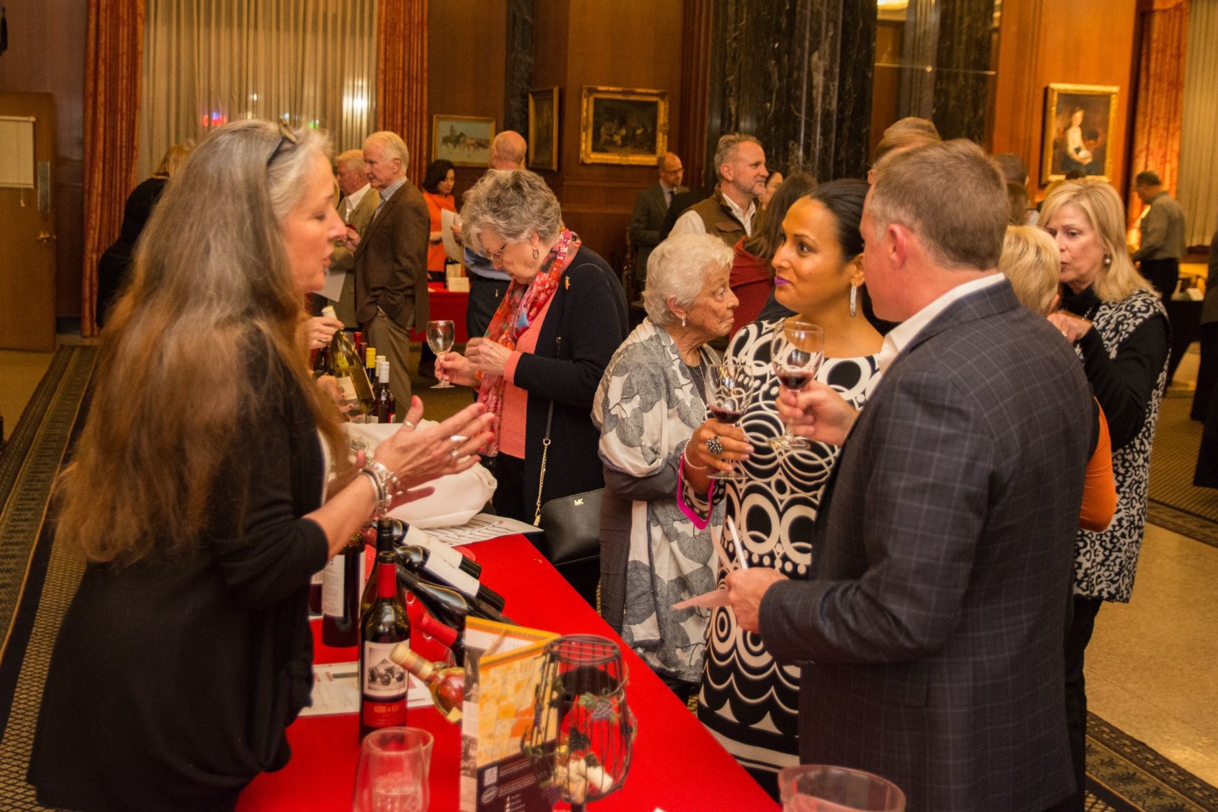 Attendees learn about the fine wines available at the event